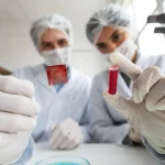 Lab technicians testing ferritin levels and supporting iron supplementation for blood donors